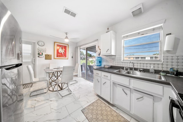155 N Riomar Dr N, Port Saint Lucie, FL 34952 - kitchen with freestanding refrigerator, dark countertops, visible vents, ceiling fan, and marble finish floor