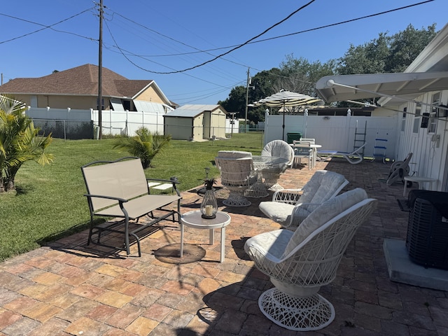 155 N Riomar Dr N, Port Saint Lucie, FL 34952 - view of patio / terrace featuring a storage shed, central air condition unit, an outbuilding, and a fenced backyard