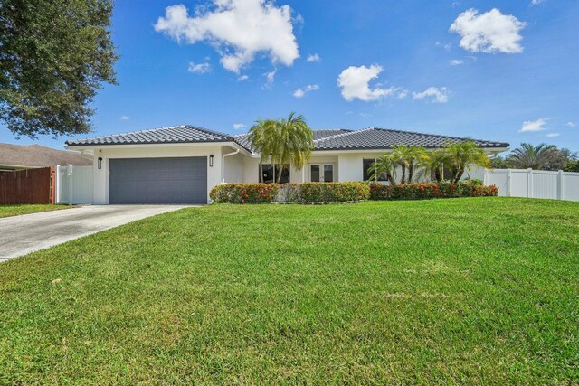 21830 Banyanwood Rd, Boca Raton, FL 33433 - ranch-style home with concrete driveway, stucco siding, a front yard, a garage, and a tiled roof