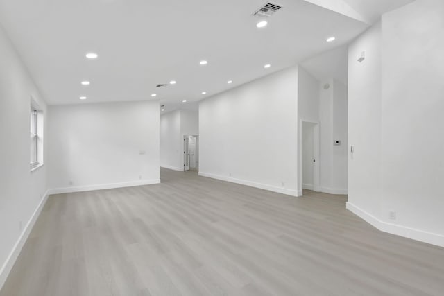 empty room featuring recessed lighting, visible vents, light wood finished floors, and baseboards