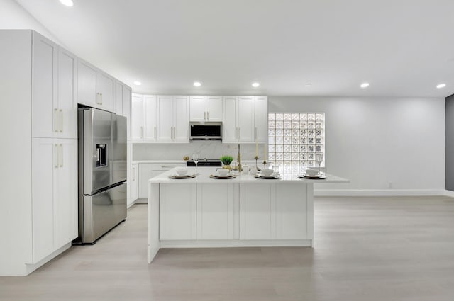 kitchen featuring recessed lighting, light wood-type flooring, and stainless steel appliances