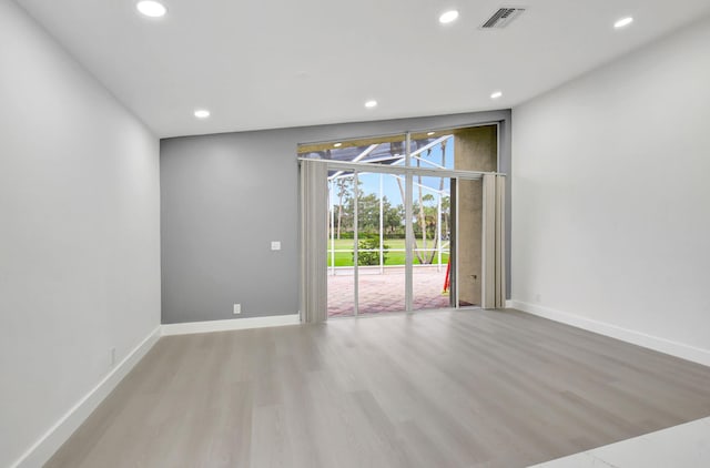 unfurnished room featuring wood finished floors, visible vents, and recessed lighting