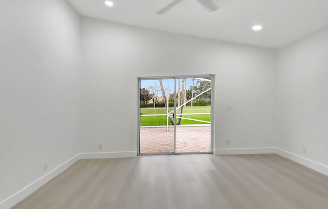 empty room featuring recessed lighting, vaulted ceiling, a ceiling fan, light wood-style floors, and baseboards