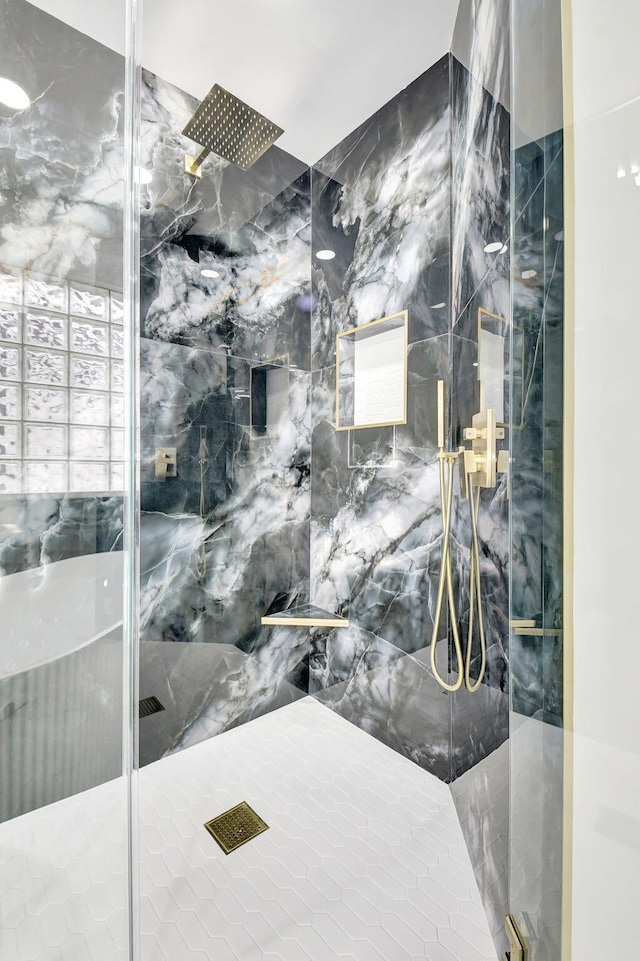 full bath with a marble finish shower