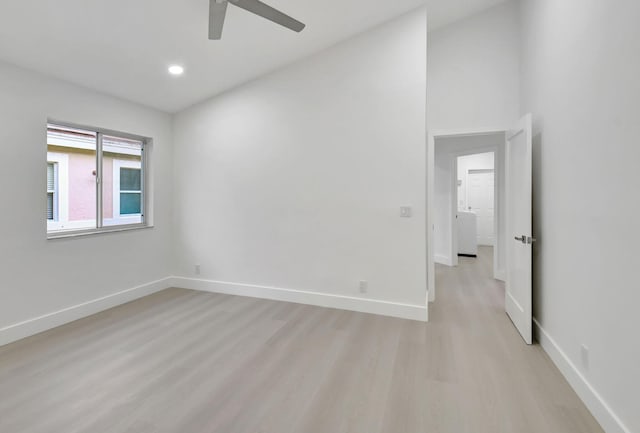 spare room featuring light wood finished floors, a ceiling fan, baseboards, and recessed lighting