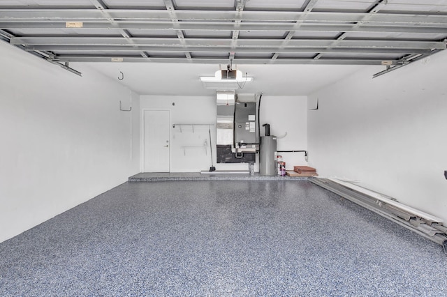 garage featuring water heater, heating unit, and a garage door opener