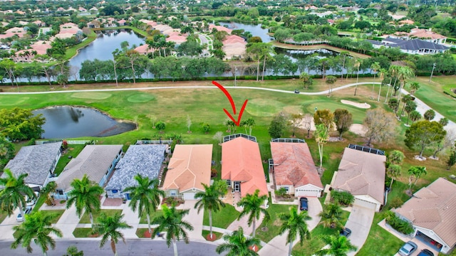 aerial view with view of golf course, a water view, and a residential view