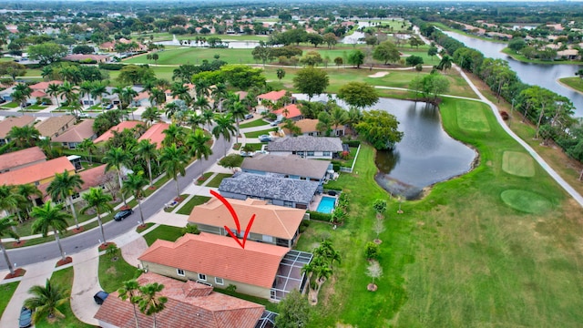 bird's eye view with golf course view, a water view, and a residential view