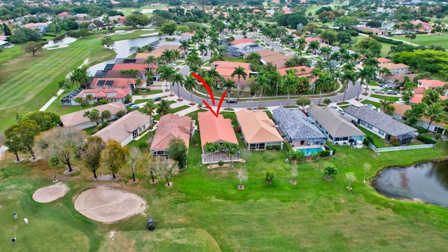 aerial view featuring view of golf course, a water view, and a residential view