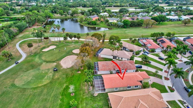 birds eye view of property with a residential view, a water view, and golf course view