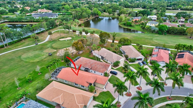 birds eye view of property featuring view of golf course, a residential view, and a water view