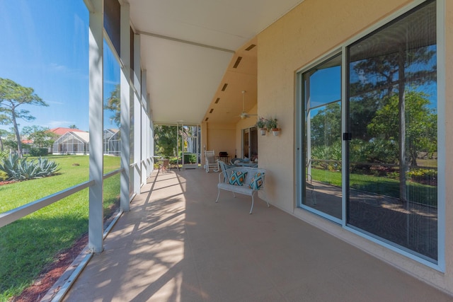 view of patio / terrace with a ceiling fan and a lanai