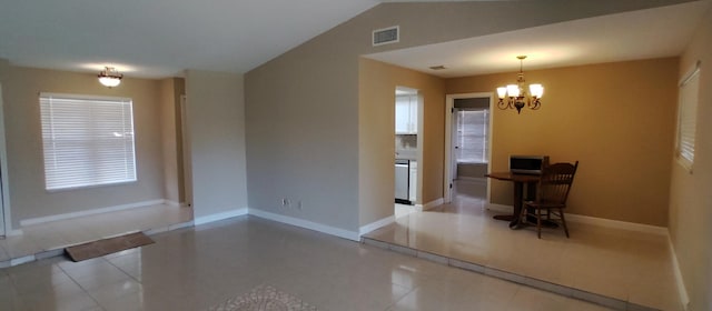 unfurnished dining area featuring tile patterned floors, vaulted ceiling, baseboards, visible vents, and a chandelier