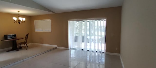 interior space featuring vaulted ceiling, baseboards, tile patterned floors, and a chandelier
