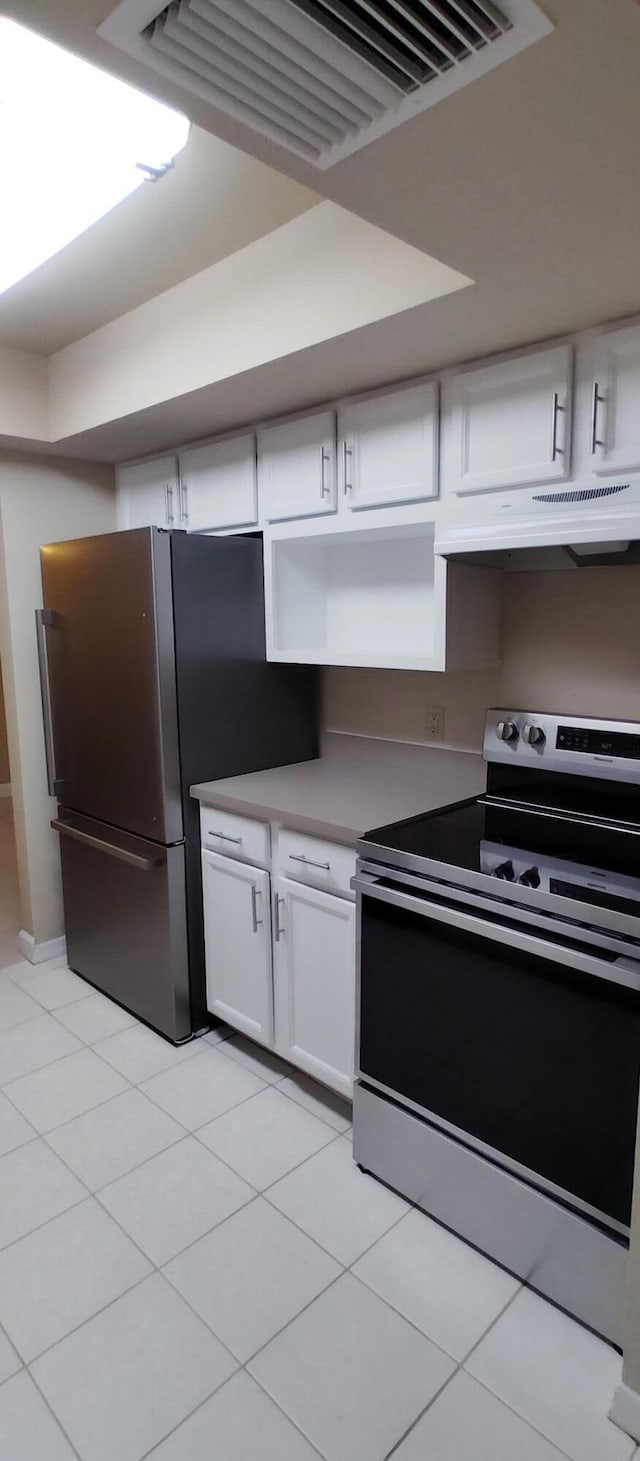 kitchen with visible vents, white cabinetry, appliances with stainless steel finishes, under cabinet range hood, and light tile patterned floors