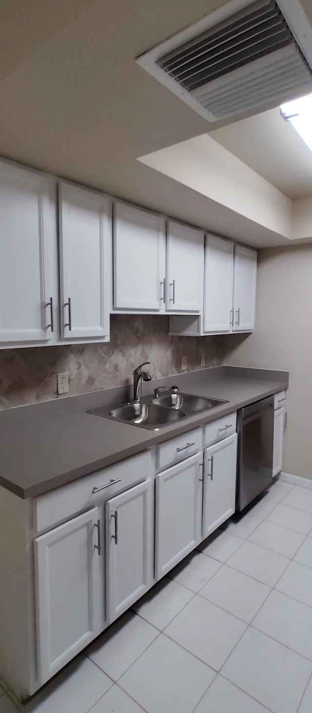 kitchen with dishwasher, visible vents, a sink, and white cabinetry