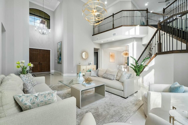 living room with crown molding, a notable chandelier, and stairs