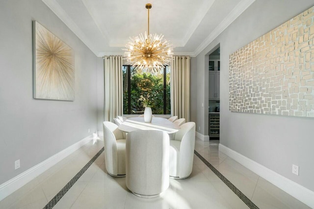 dining area featuring crown molding, baseboards, a raised ceiling, and an inviting chandelier