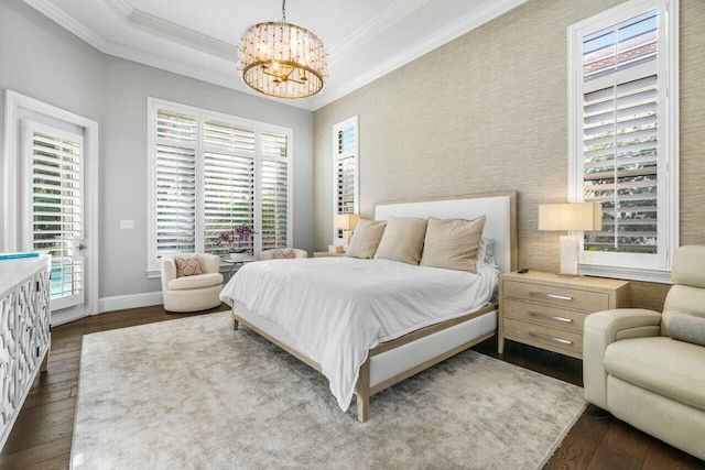bedroom with access to outside, an inviting chandelier, dark wood-type flooring, ornamental molding, and baseboards