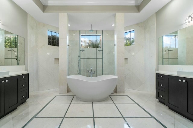 bathroom with tile walls, a freestanding bath, and vanity