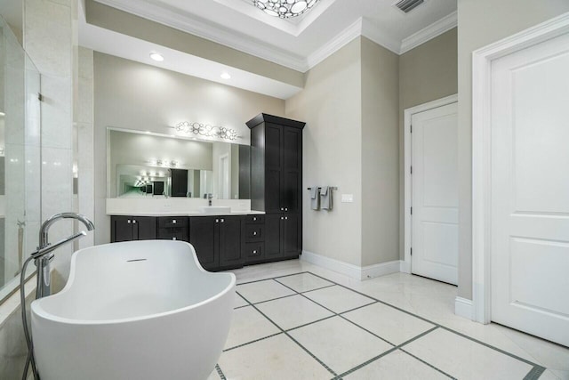full bathroom featuring crown molding, vanity, tile patterned flooring, a freestanding bath, and baseboards