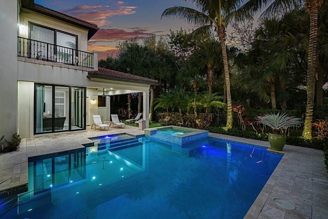 view of swimming pool featuring a patio area and a pool with connected hot tub