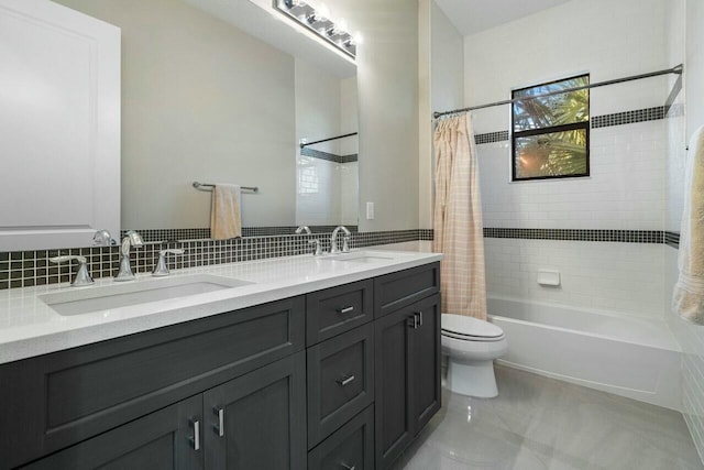 full bathroom with shower / bath combination with curtain, double vanity, a sink, and toilet
