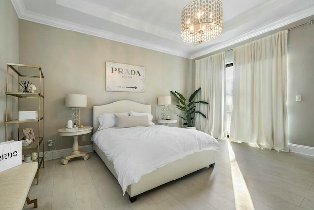 bedroom featuring light wood finished floors, a notable chandelier, baseboards, and ornamental molding