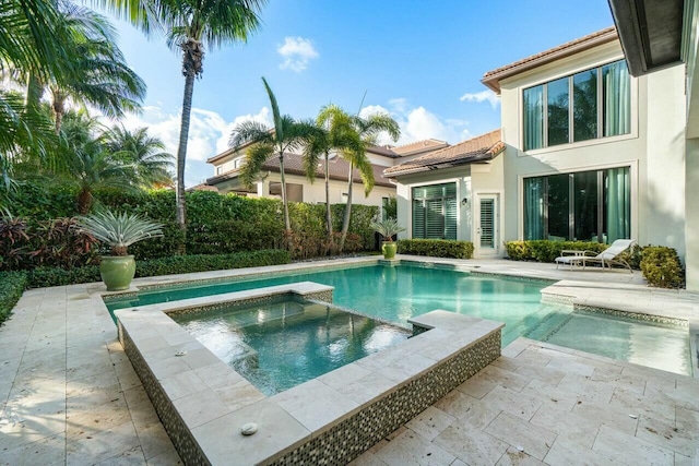 view of swimming pool with a pool with connected hot tub and a patio