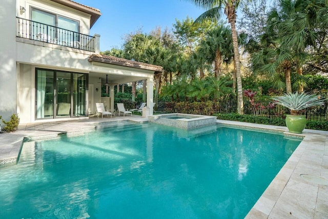view of pool featuring a patio and a pool with connected hot tub