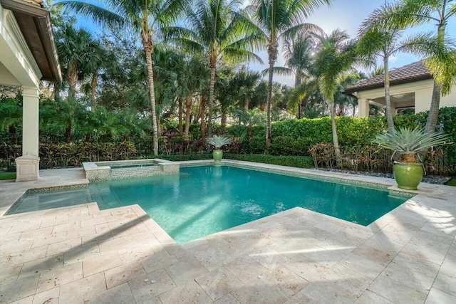 view of swimming pool with a pool with connected hot tub and a patio