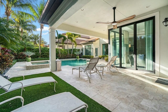 view of patio / terrace featuring a fenced in pool, an in ground hot tub, and ceiling fan