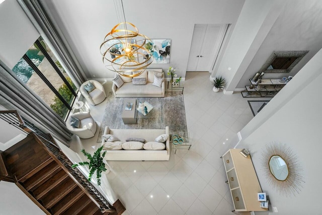 tiled living room with an inviting chandelier