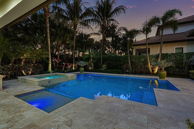 view of pool with a patio area and a pool with connected hot tub