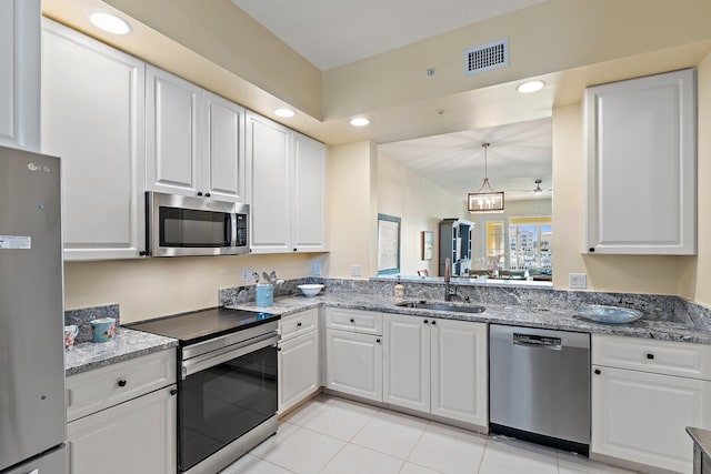 kitchen with white cabinets, visible vents, stainless steel appliances, and a sink