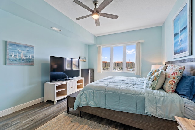 bedroom featuring visible vents, baseboards, a ceiling fan, and wood finished floors