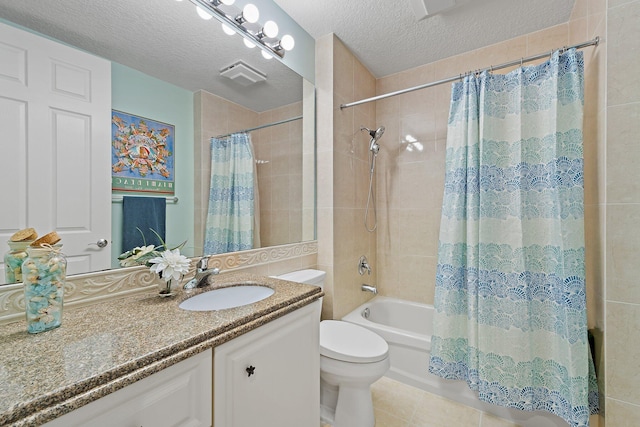 bathroom featuring shower / bath combo, tile patterned floors, a textured ceiling, vanity, and toilet