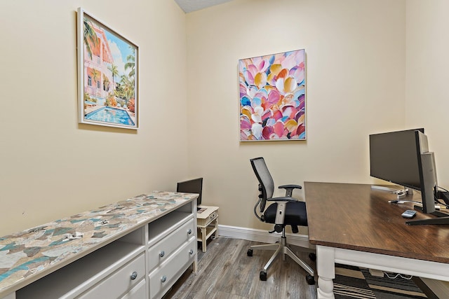 office space with wood finished floors and baseboards