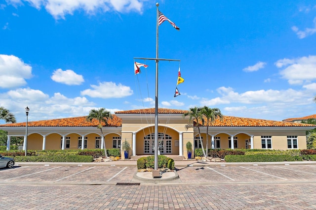 view of building exterior with uncovered parking