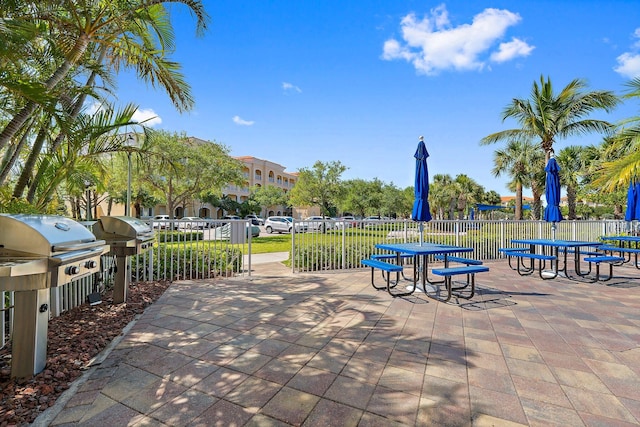 view of patio featuring grilling area and fence