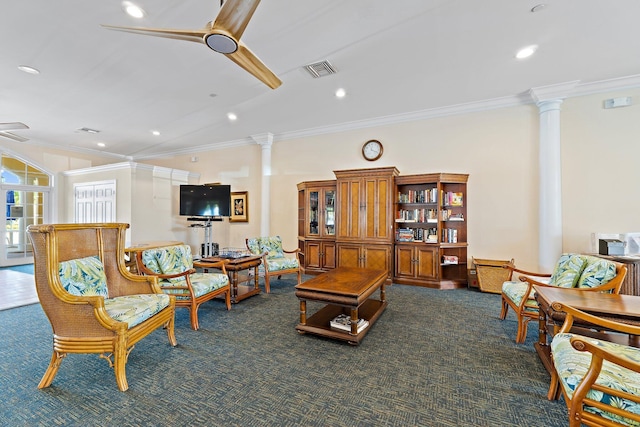 living area featuring dark colored carpet, ornamental molding, ceiling fan, and decorative columns