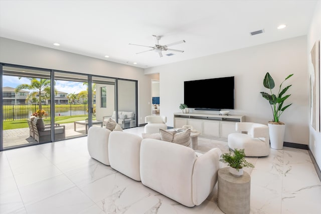 living area with light marble finish floors, recessed lighting, a ceiling fan, and baseboards