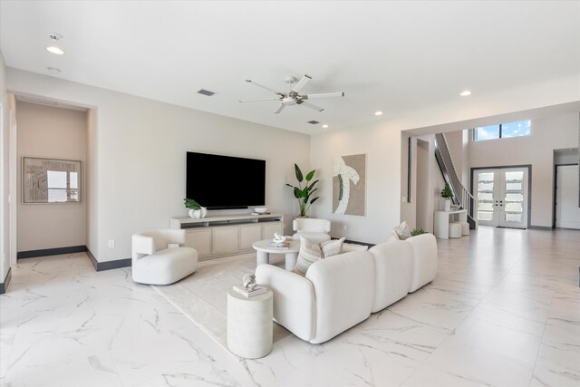 living area with recessed lighting, light marble finish floors, ceiling fan, and baseboards