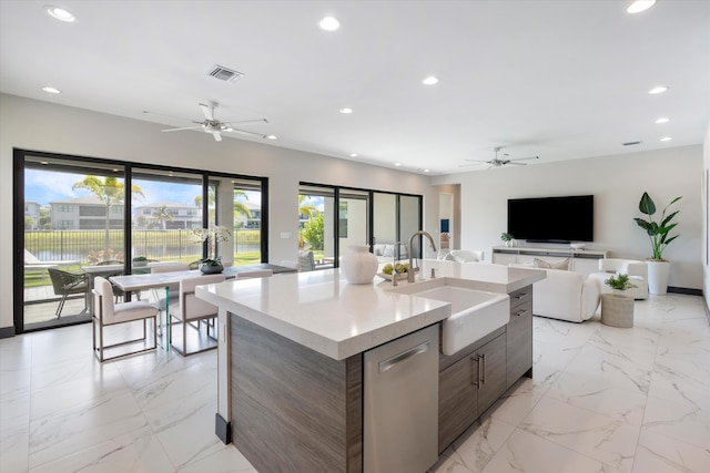 kitchen with a ceiling fan, a sink, modern cabinets, recessed lighting, and light countertops