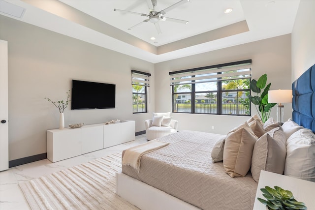 bedroom with multiple windows, recessed lighting, a raised ceiling, baseboards, and a ceiling fan