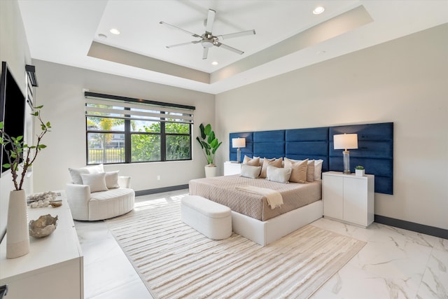 bedroom featuring baseboards, recessed lighting, light marble finish floors, a raised ceiling, and ceiling fan