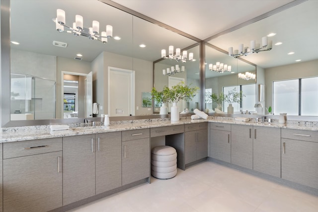 full bath with a stall shower, a chandelier, two vanities, healthy amount of natural light, and recessed lighting