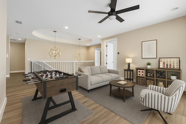 living area featuring a ceiling fan, light wood-type flooring, baseboards, and recessed lighting
