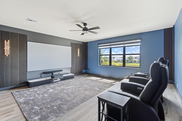 cinema featuring a ceiling fan, wood finished floors, and baseboards
