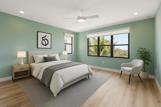 bedroom featuring baseboards, light wood finished floors, ceiling fan, and recessed lighting